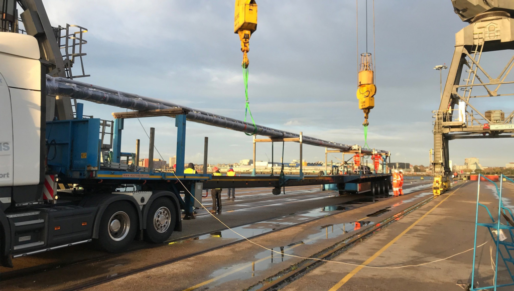 a large pole being lifted by a crane