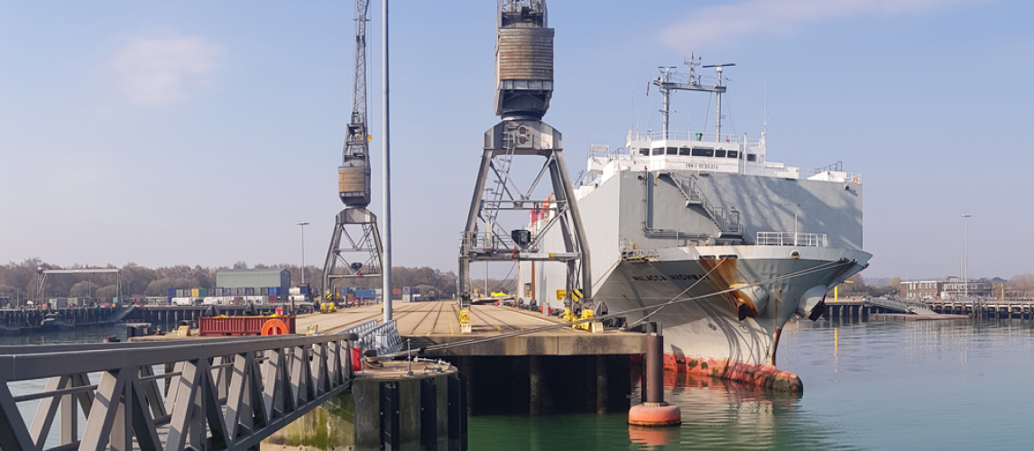 a large, grey container ship docked