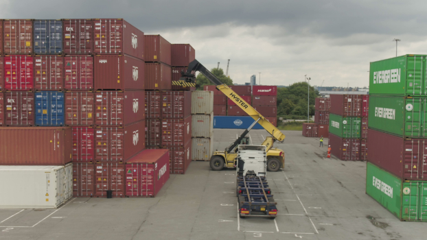 red and green shipping containers stacked high