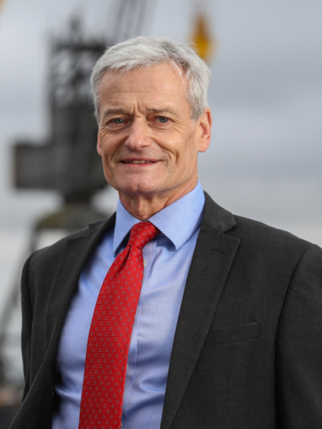richard parkinson in a suit smiling at the camera