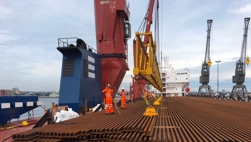 an empty container boat with people working on the boat