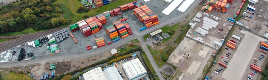 a bird's eye view of a port with containers in storage